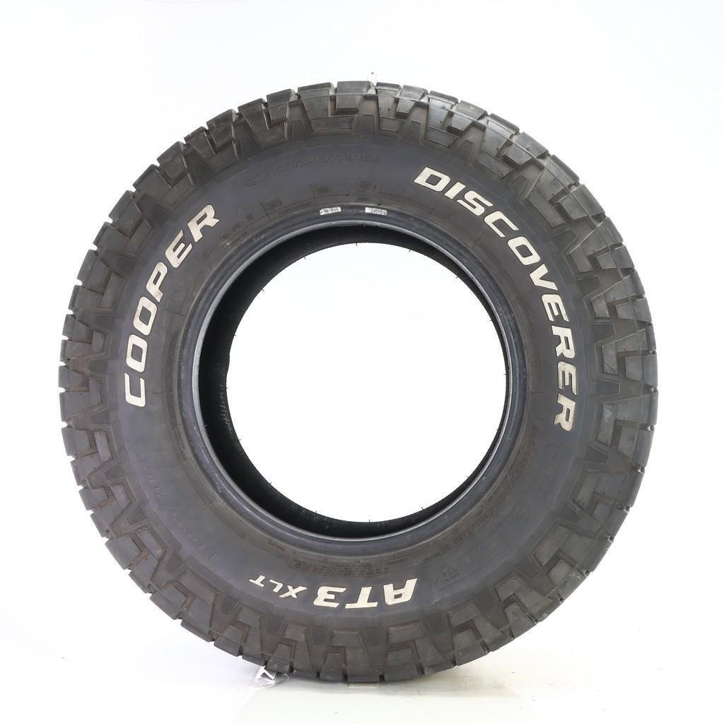 Image of Cooper Discoverer AT3 XLT tire. A heavy-duty all-terrain tire designed for overlanding, offering robust construction, strong gravel and loose dirt traction, and durable tread for long-lasting performance under heavy loads.