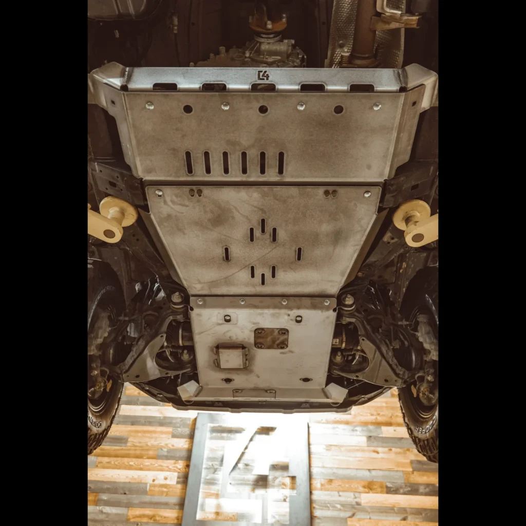 "Image of C4 Fabrication Overland Series Skid Plates installed on a vehicle, showcasing robust steel or aluminum construction designed for lightweight and durable underbody protection, ideal for serious off-road and overland adventures."