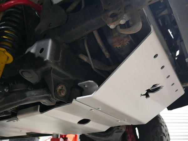 "Image of Talons Offroad skid plates installed under a vehicle, showcasing heavy-duty steel or aluminum construction designed to protect vital components like the engine, transmission, and fuel tank during off-road adventures."